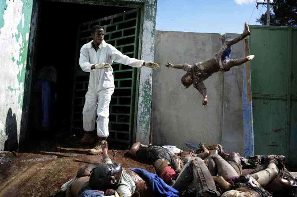  1st Prize General News Stories
Haiti earthquake aftermath, 15-26 January
A man throws a dead body at the morgue of the general hospital, Port-au-Prince, 15 January