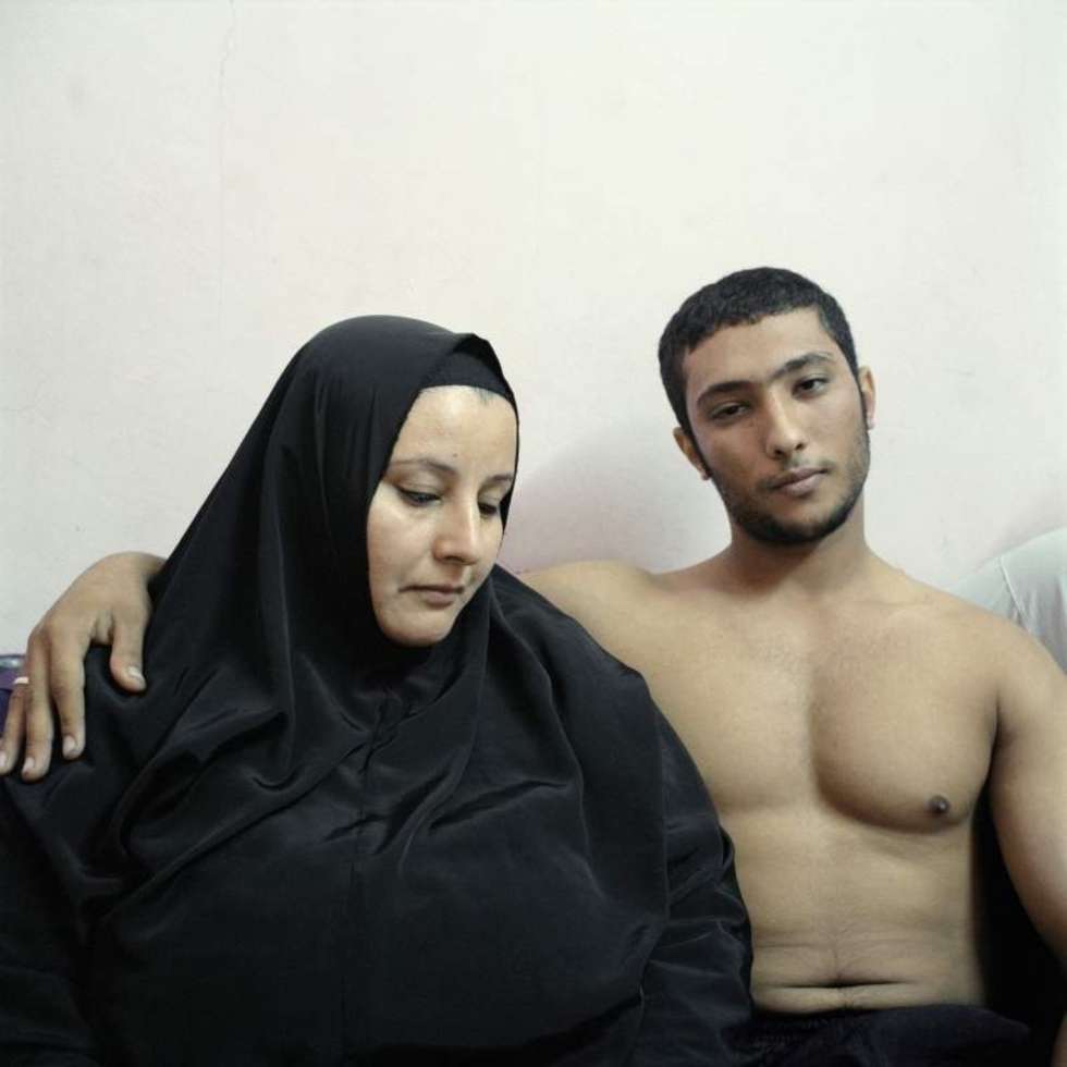  2nd Prize People &#8211; Staged Portraits Stories    03 February 2011, Cairo, Egypt  Ali, a young Egyptian bodybuilder, poses with his mother.