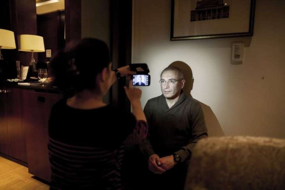  <b>Zdjęcie pojedyncze - II miejsce w kategorii LUDZIE</b><br /><br />Berlin. Michaił Chodorkowski zaraz po tym, jak został wypuszczony z rosyjskiego łagru, przyjechał do Berlina, by stąd dotrzeć do rodziny w Szwajcarii. Na zdjęciu kuca pod ścianą pokoju hotelowego, pozując swojej współpracowniczce, która robi mu telefonem komórkowym zdjęcie do dokumentów. 23 grudnia 2013