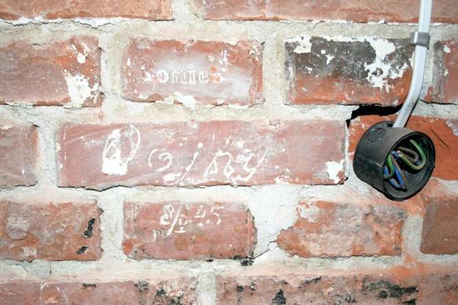 „Koniec wojny”, jedna z inskrypcji odkrytych na murze dawnej celi, w piwnicy WKU (fot. Radosław Szczęch)