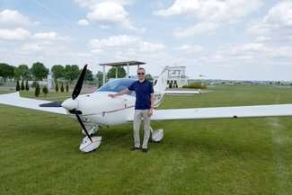 Prorektor Arkadiusz Teofil na tle cruisera, na którym będą się szkolić studenci