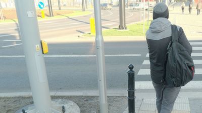 Przycisk mający służyć do włączania zielonego światła na przejściu przez jezdnię ul. Fabrycznej zamontowany jest w sporej odległości od chodnika, co może być kłopotliwe dla osób poruszających się na wózkach