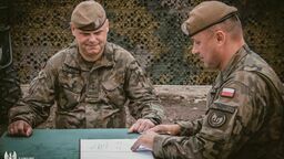 Ppłk Michał Zając (pierwszy z prawej) podpisuje akt przejęcia  batalionu terytorialsów w Kraśniku

